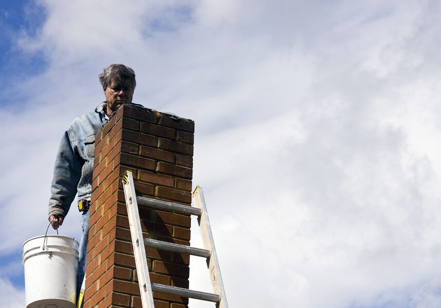 a brick chimney with a ladder